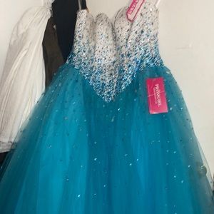 teal prom dress with a white corset top and gems